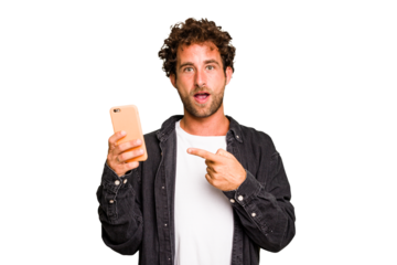 Young caucasian man using mobile phone isolated pointing to the side