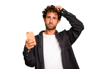 Young caucasian man using mobile phone isolated being shocked, she has remembered important meeting.