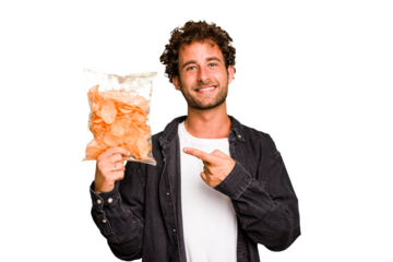 Young caucasian man holding crips isolated smiling and pointing aside, showing something at blank space.