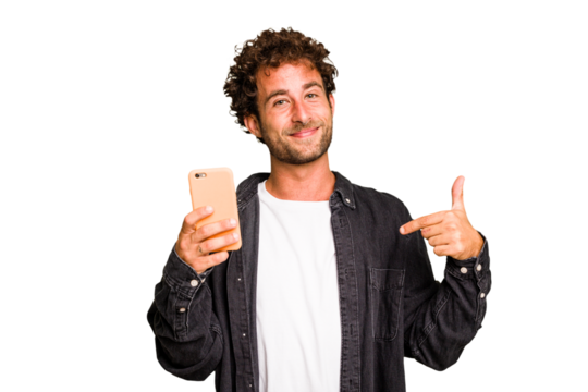 Young caucasian man using mobile phone isolated person pointing by hand to a shirt copy space, proud and confident