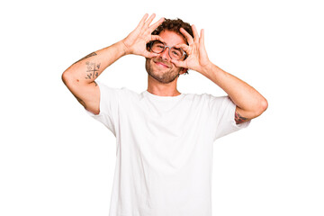 Young caucasian curly hair man isolated Young caucasian man with curly hair isolated showing okay sign over eyes