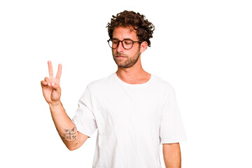 Fototapeta premium Young caucasian curly hair man isolated Young caucasian man with curly hair isolated joyful and carefree showing a peace symbol with fingers.