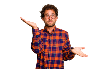 Young caucasian curly hair man isolated Young caucasian man with curly hair isolated confused and doubtful shrugging shoulders to hold a copy space.