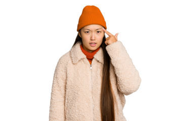 Young asian woman wearing winter clothes isolated on green chroma background showing a disappointment gesture with forefinger.