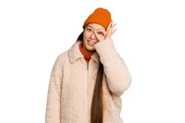 Young asian woman wearing winter clothes isolated on green chroma background excited keeping ok gesture on eye.