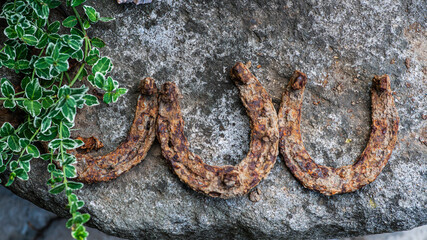 Garden decorations made of stones and stone sculptures among nice greens.