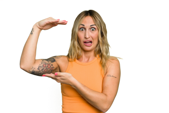 Young caucasian woman isolated on green chroma background shocked and amazed holding a copy space between hands.