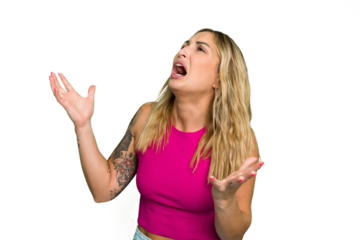 Young caucasian woman isolated on green chroma background screaming to the sky, looking up, frustrated.
