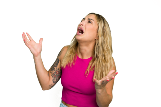 Young caucasian woman isolated on green chroma background screaming to the sky, looking up, frustrated.
