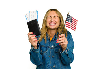 Young caucasian woman holding a passport and USA flag isolated on green chroma background