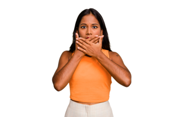 Young Indian woman isolated covering mouth with hands looking worried.