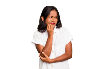 Young Indian woman isolated biting fingernails, nervous and very anxious.