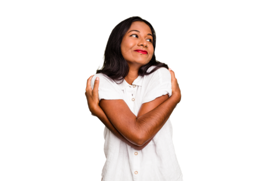 Young Indian woman isolated hugs, smiling carefree and happy.