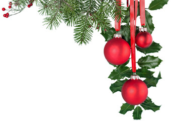 Red Christmas toys weigh on green branch isolated on white background