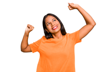 Young Indian woman isolated celebrating a special day, jumps and raise arms with energy.