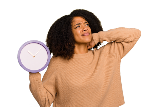 Young African American holding a clock isolated touching back of head, thinking and making a choice.