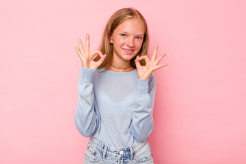 Caucasian teen girl isolated on pink background cheerful and confident showing ok gesture.