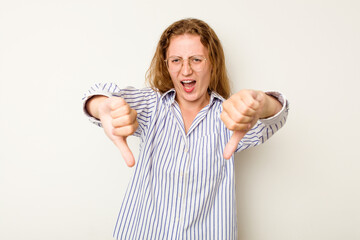 Young caucasian woman isolated on white background showing thumb down and expressing dislike.