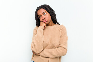 Young African American woman isolated on white background tired of a repetitive task.