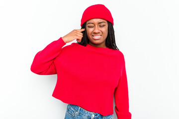 Young African American woman isolated on white background covering ears with hands.