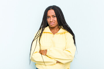 Young African American woman with braids hair isolated on blue background unhappy looking in camera...