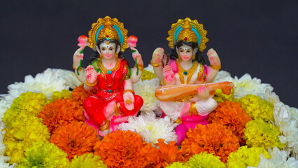 Statue of Indian God Lakshmi and Saraswati. Hindu gods. Holiday banner or greeting card for Indian festival Happy Diwali.