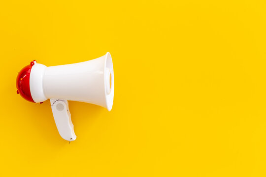 White Megaphone Against The Empty Wall. Hiring Or Advertising Concept
