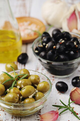 Black and green olives in glass bowls	