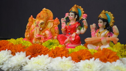 Statue of Indian God Lakshmi Ganesha and Saraswati. Lakshmi and Ganesha - Hindu gods. Holiday...