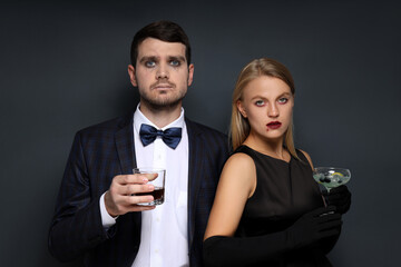 Concept of Halloween, young man and woman on dark background