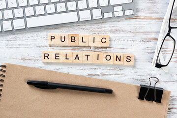 Public relations concept with letters on cubes