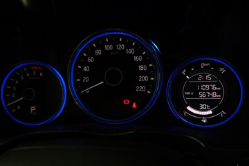 Modern car dashboard with illumination. Car panel instrument speedometer