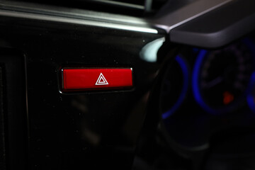 Obraz premium Vehicle, car hazard warning flashers button with visible red triangle.