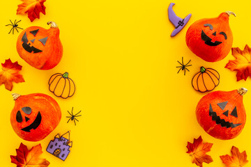 Halloween holiday background with pumpkin head and dry leaves, top view
