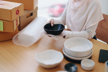 Beautiful Muslim woman selling online at home, business owner, business sme concepts