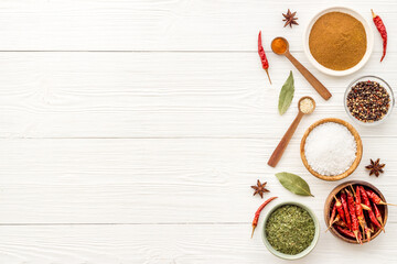 Cooking ingredients - colorful spices and herbs in bowls, top view