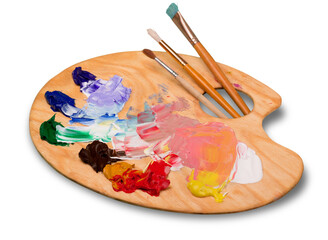 Wooden art palette with blobs of paint and a brushes on white background - obrazy, fototapety, plakaty