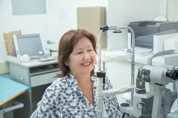 A woman checks her eyesight with a doctor using a slit lamp. The concept of biomicroscopy of the eye.
