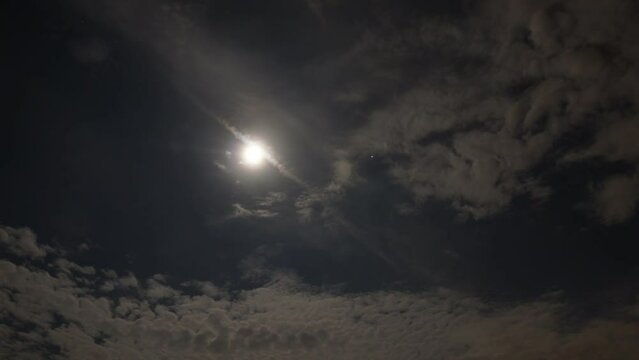 Night time cloudy sky time-lapse with full moon and jupiter
