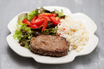 three fried ground meat with fresh salad on white plate