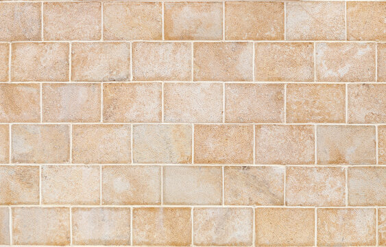 Wall made of smooth, rectangular yellow Sandstone blocks. Background image, texture.