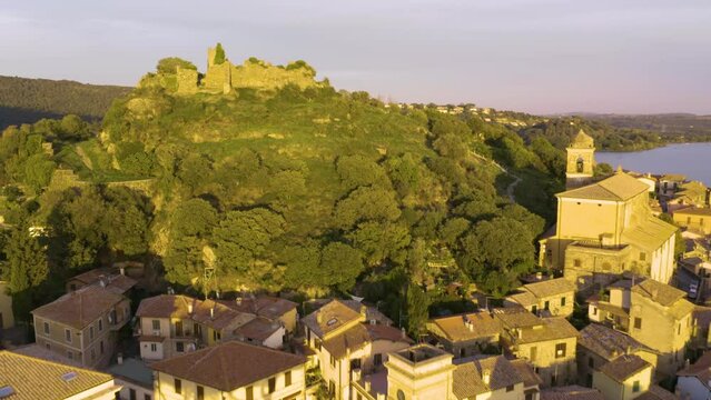 Drone Shot Reveals Orsinis Fortress on Lake Bracciano at Sunset
