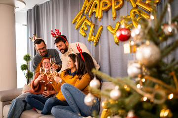 Young people toast with champagne during Christmas