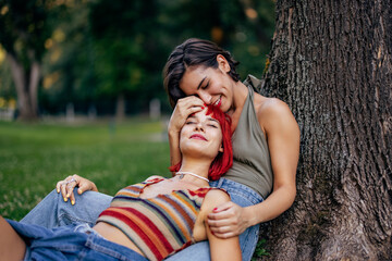 Close up of two female lovers, enjoying together, in the park.