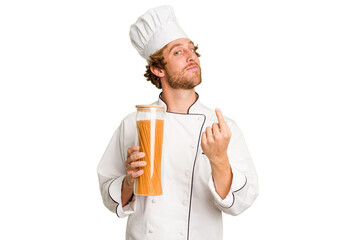 Young cook man isolated on white background pointing with finger at you as if inviting come closer.
