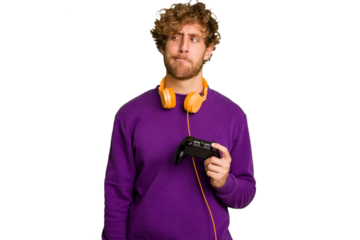 Young caucasian gamer man holding a game controller isolated on white background confused, feels doubtful and unsure.
