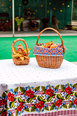 Fototapeta na wymiar Autumn composition baskets with autumn leaves and berries stand on a white table