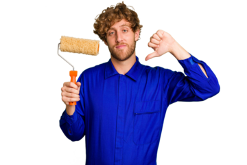 Young painter man holding a roll isolated on white background showing a dislike gesture, thumbs down. Disagreement concept.