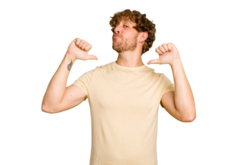 Young caucasian man isolated on green chroma background feels proud and self confident, example to follow.