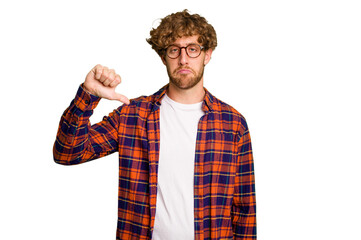 Young caucasian man isolated on green chroma background showing a dislike gesture, thumbs down....